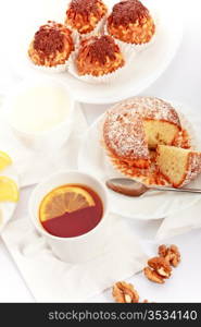 tea with lemon and fancy cakes, still life