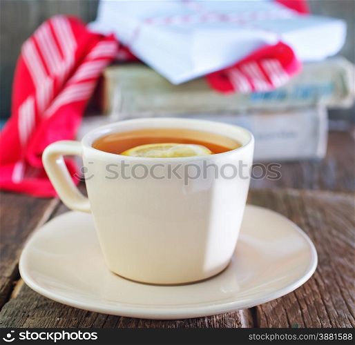 tea with lemon in cup and on a table