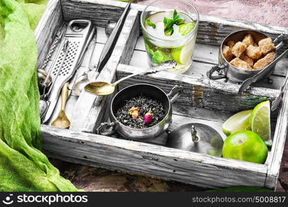 Tea with lime. Retro tray with herb tea,lime,ingredients and utensils