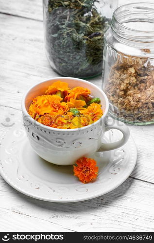 Tea with marigolds. Herbal medicinal tea of marigold flowers as a cold remedy