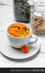 Tea with marigolds. Herbal medicinal tea of marigold flowers as a cold remedy