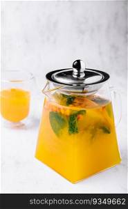 tea with mint and orange. aromatic hot drink in glass jar.