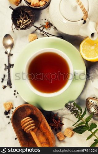 Tea with mint, ginger and lemon on rustic background