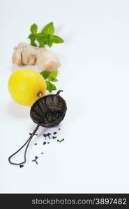 Tea with mint, ginger and lemon on white background