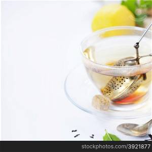 Tea with mint, ginger and lemon on white background