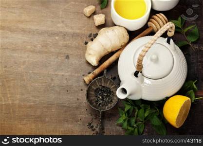 Tea with mint, ginger and lemon on wooden background (asian food concept)