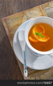 Tea with orange slices and mint leaves