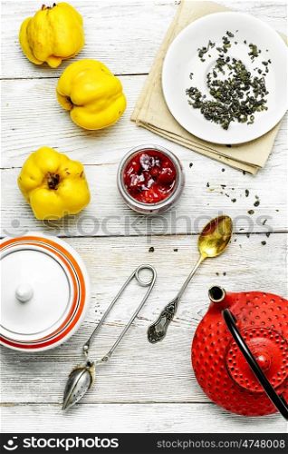 Tea with quince and jam. Tea with jam from the ripe fruit of autumn quince.View top