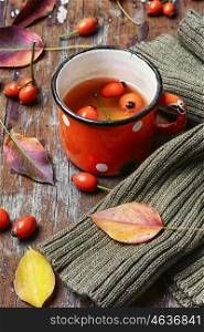 tea with rosehips. Cup of healing tea with autumn hips