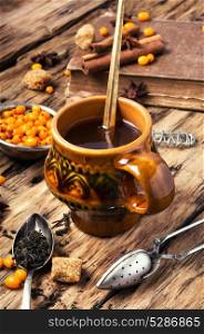 tea with sea-buckthorn. autumn sea-buckthorn tea on an old vintage wooden background