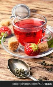 tea with strawberry. Fruit tea with summer strawberries in a glass cup