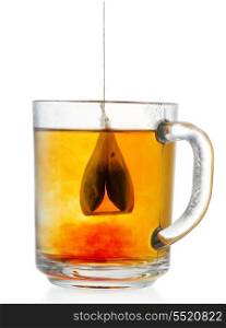 Teabag in the cup with water on white background
