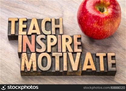 teach, inspire, motivate concept in vintage letterpress wood type printing blocks with an apple
