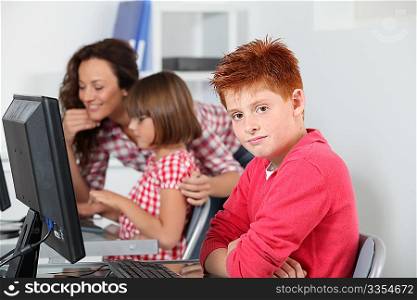 Teacher and children learning to use computer