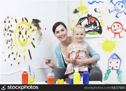 Teacher And Pupil In Pre School Art Class