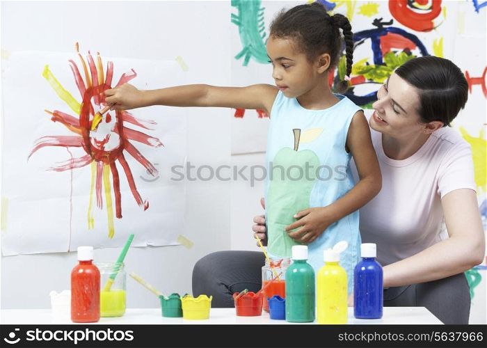 Teacher And Pupil In Pre School Art Class