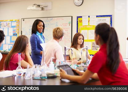 Teacher And Pupils In High School Science Class