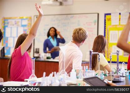 Teacher And Pupils In High School Science Class