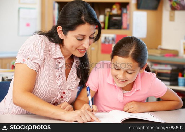 Teacher and schoolgirl in class