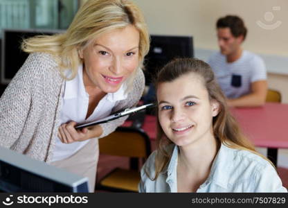 teacher and student sitting at table