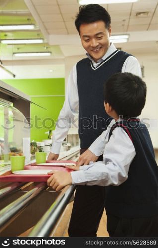 Teacher and student talking in school cafeteria