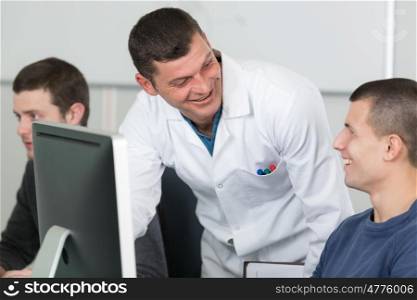 teacher and students during informatics class