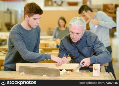teacher and students in carpentry class