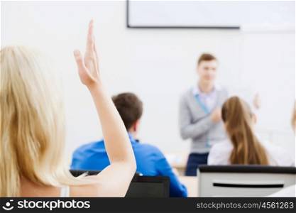 Teacher at lesson. Young teacher in classroom standing in front of class