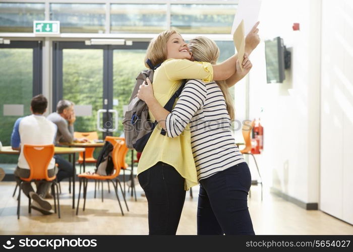 Teacher Congratulating Pupil On Successful Exam Result