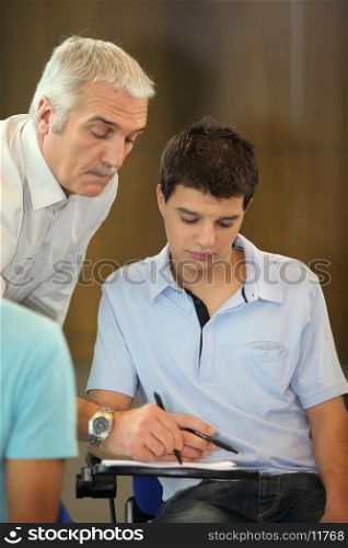 Teacher correcting his student's homework