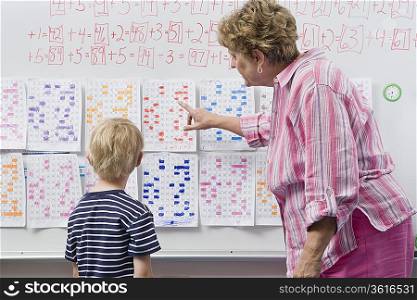 Teacher Explaining Calendar to Little Boy