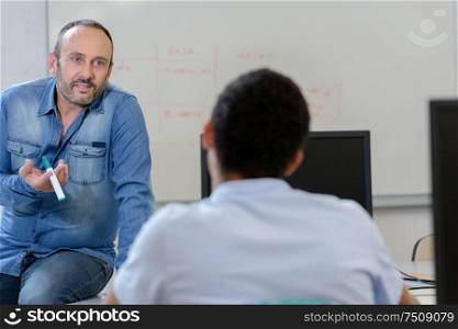 teacher giving lesson to college students