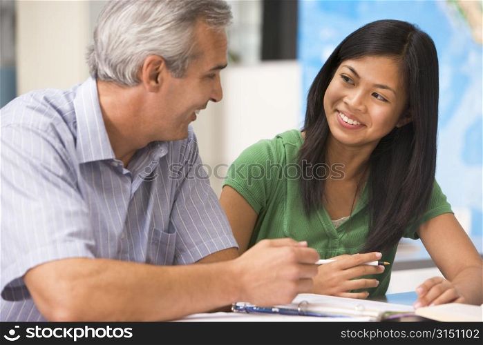 Teacher giving personal instruction to female student