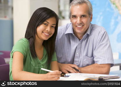 Teacher giving personal instruction to female student