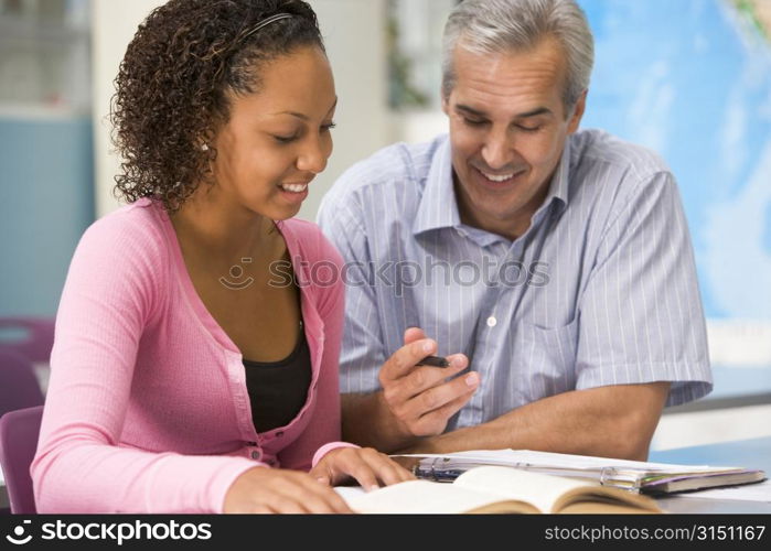 Teacher giving personal instruction to female student