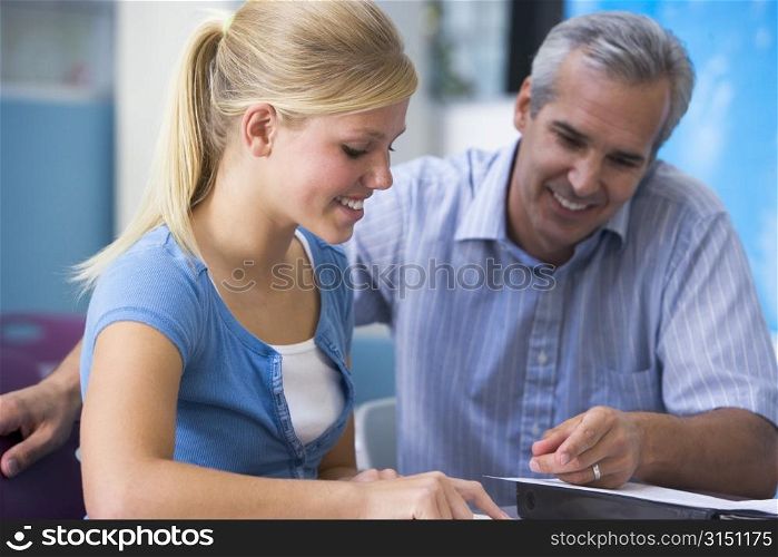 Teacher giving personal instruction to female student