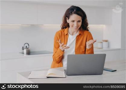 Teacher has lesson online on laptop. Female european tutor is teaching her students language online. Remote class and distance education at home on quarantine. E-learning via zoom.. Teacher has lesson online on laptop. Remote class and distance education at home on quarantine.