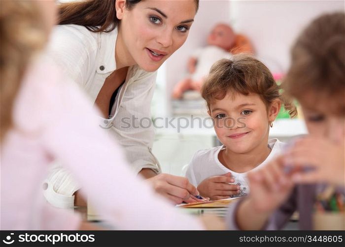 Teacher helping children in class