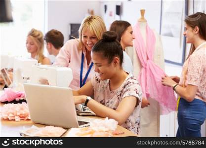 Teacher Helping College Students Studying Fashion And Design
