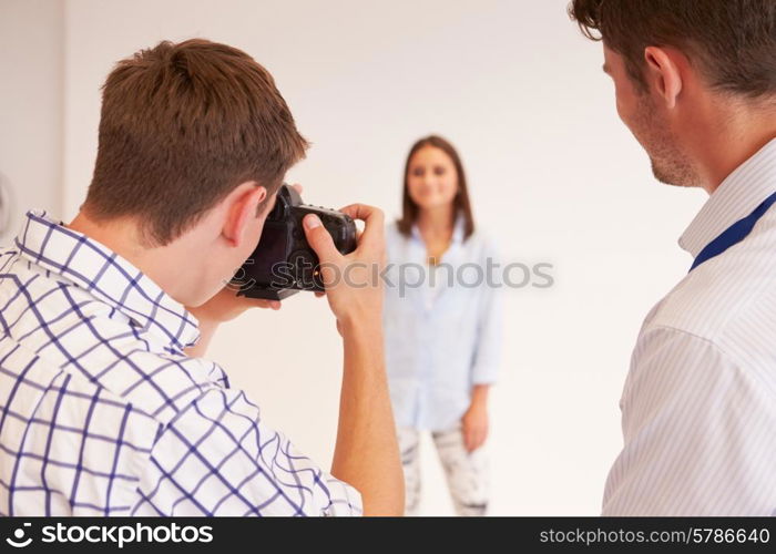 Teacher Helping College Students Studying Photography