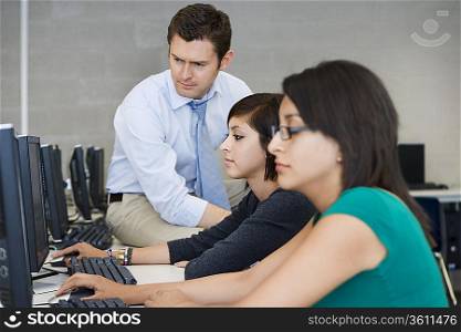 Teacher Helping Computer Students