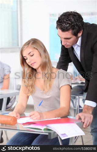 Teacher helping female student