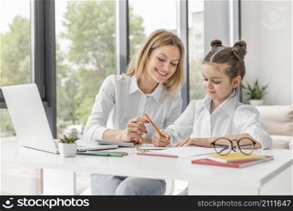 teacher helping her daughter study home
