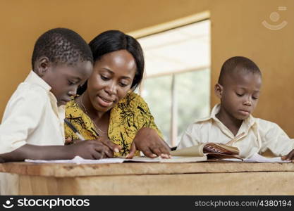 teacher helping kids class