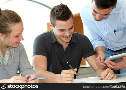 Teacher helping students with assignment