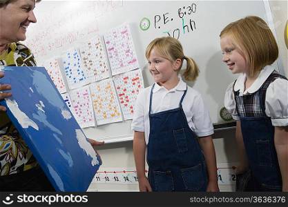 Teacher Holding Painting