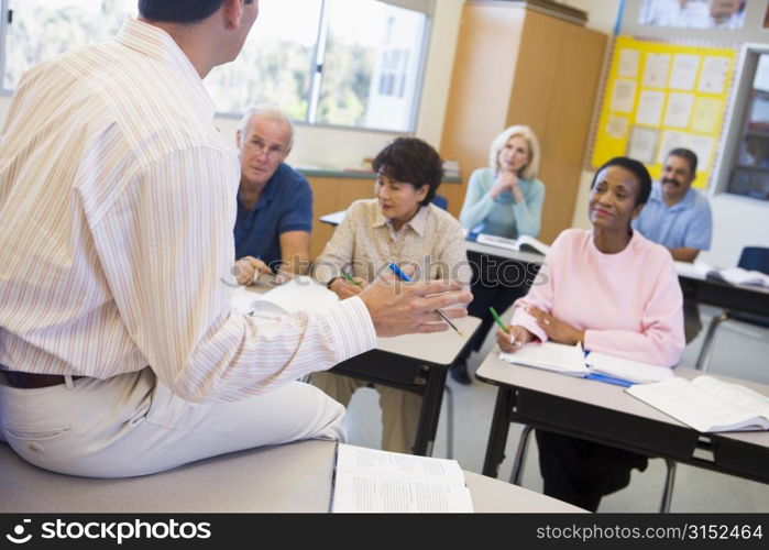 Teacher in class lecturing adult students (selective focus)