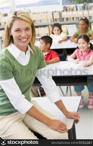 Teacher in class with students in background (selective focus)