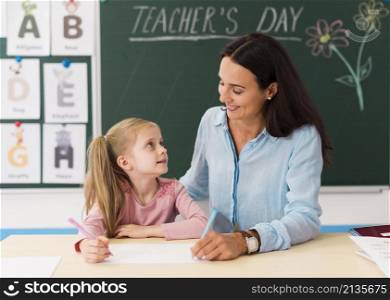 teacher looking her little student