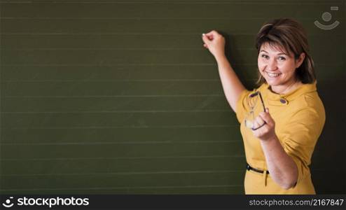 teacher pointing chalkboard with copy space